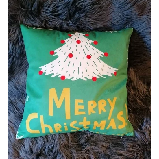 Párnahuzat zöld anyagból, "Merry Christmas" felirattal és fehér fenyőfa mintával